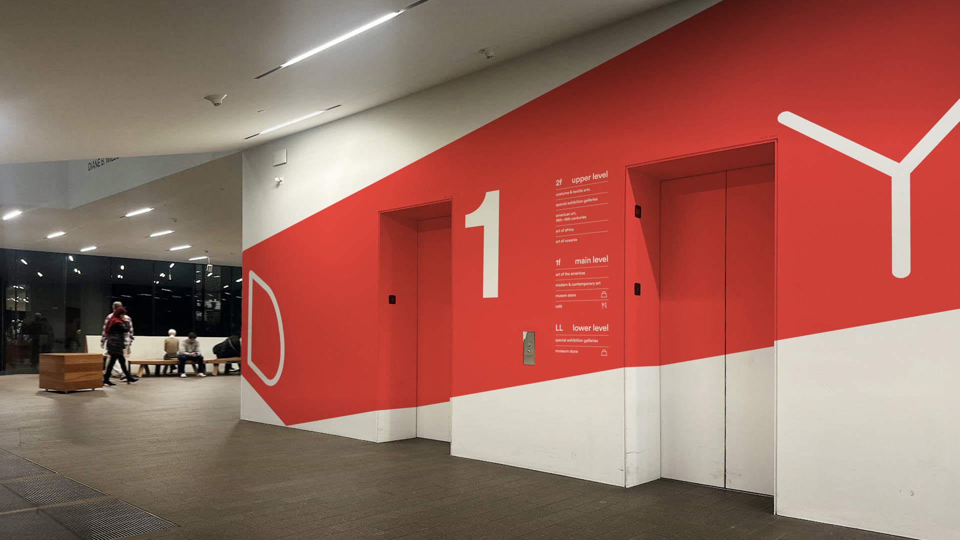 Elevator lobby wrapped in a red band carrying the D and Y