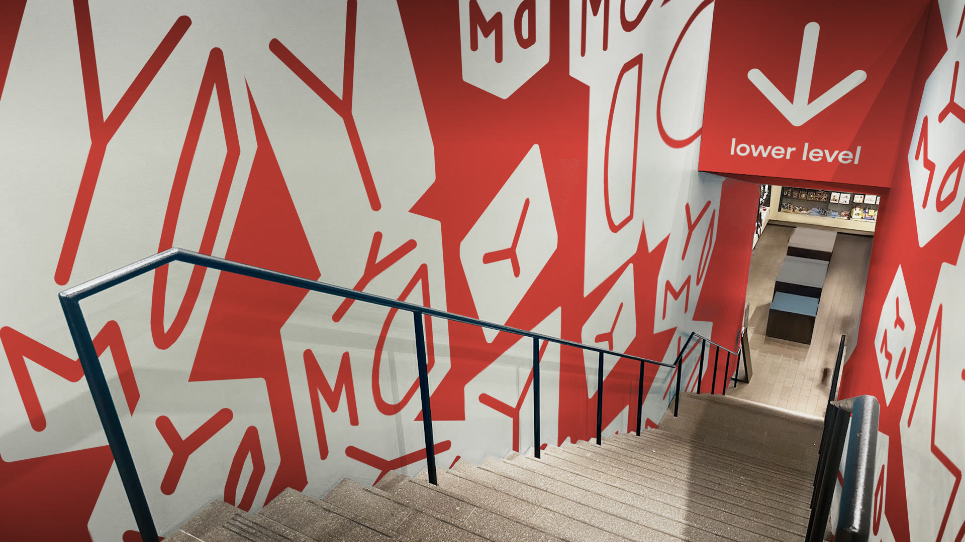 Stairwell to the lower level covered in red and white letterforms
