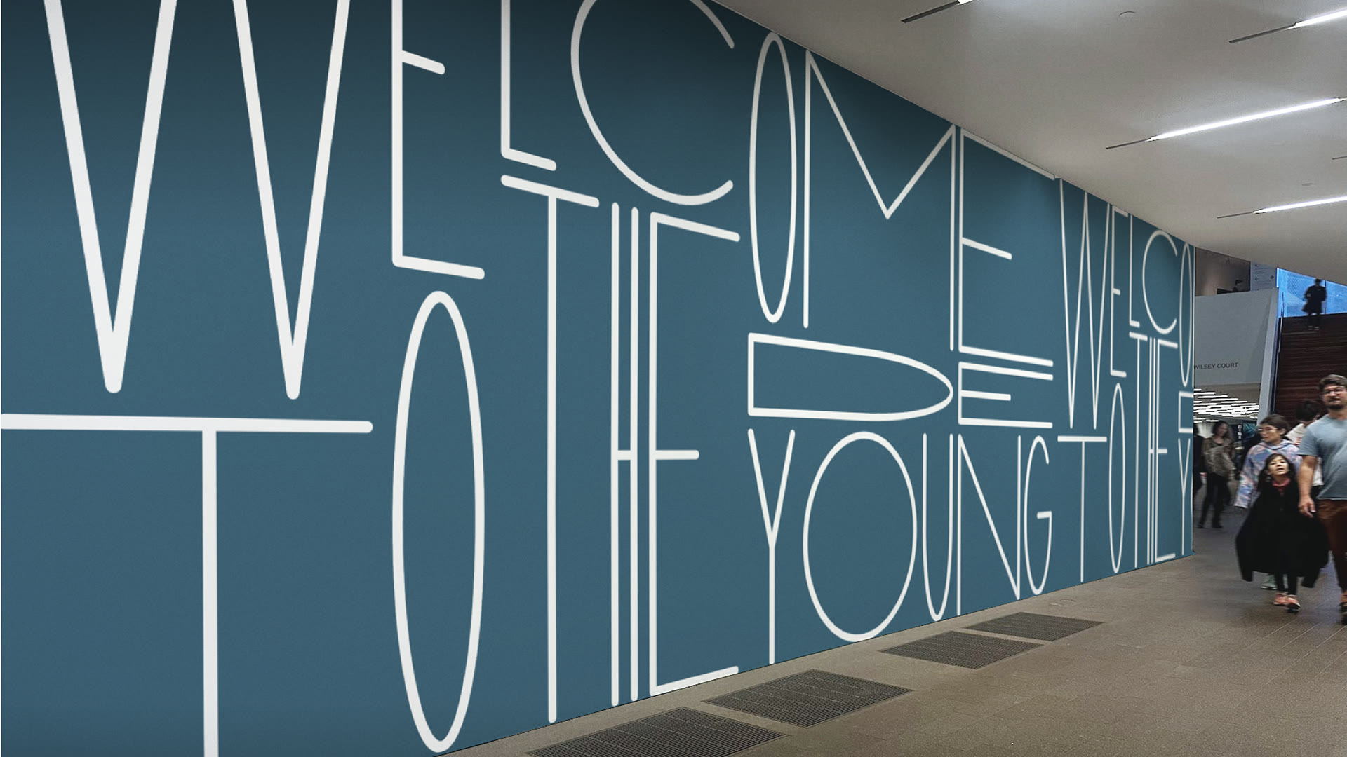 Welcome to the de Young set in stretched type across a blue wall